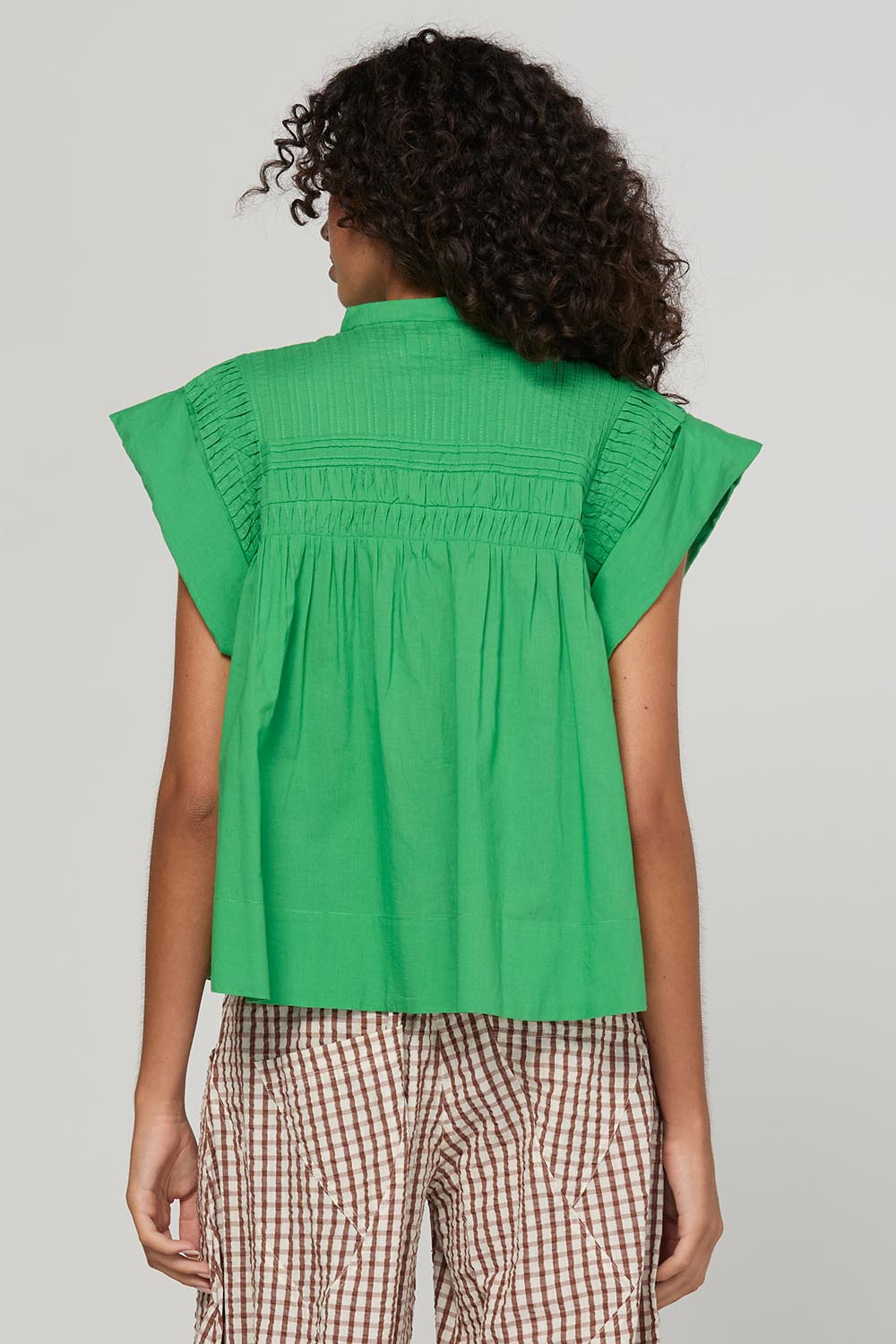 Model Genericm wearing size sample of the Danika Top – Apple in colour Apple, from the back
