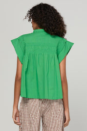 Model Genericm wearing size sample of the Danika Top – Apple in colour Apple, from the back