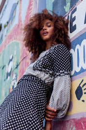 A model wearing the Stevie Top in colour Broadway (Black), from the front, showing the whole outfit