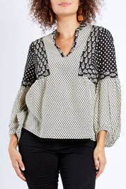 Model Lala wearing size 10 of the Stevie Top in colour Broadway (Black), from the front, cropped image