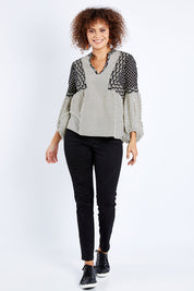 Model Lala wearing size 10 of the Stevie Top in colour Broadway (Black), from the front, showing the whole outfit