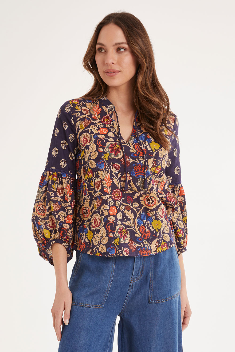 Model Madeline wearing size 10 of the Mittee Top in colour Cella (Blue), from the front, cropped image