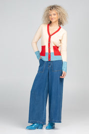 A model wearing the Poet Cardigan in colour Cream, from the front, showing the whole outfit