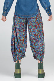 A model wearing the Guru Cotton Pant in colour Inez (Blue), from the back
