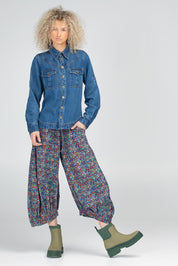 A model wearing the Guru Cotton Pant in colour Inez (Blue), from the front, showing the whole outfit