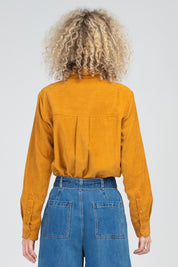 A model wearing the Metropolitan Cotton Cord Shirt in colour Marigold, from the back