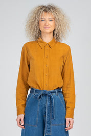 A model wearing the Metropolitan Cotton Cord Shirt in colour Marigold, from the front, cropped image