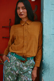 A model wearing the Metropolitan Cotton Cord Shirt in colour Marigold, from the front, showing the whole outfit