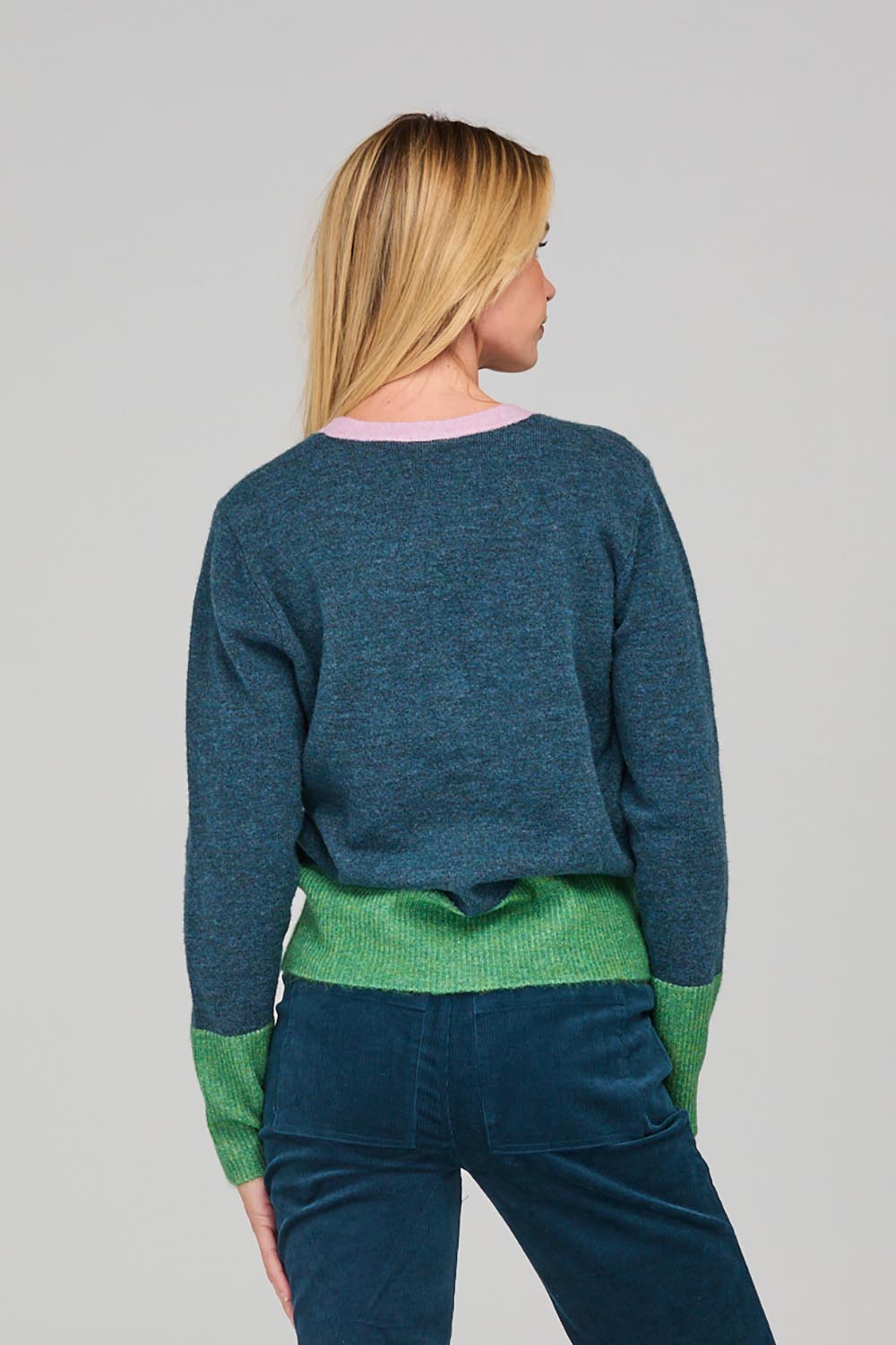 A model wearing the Poet Cardigan in colour Bluemulti (Blue), from the back