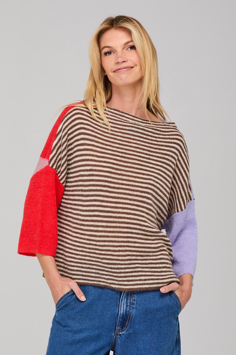 A model wearing the Neopolitan Jumper in colour Multi, from the front, cropped image