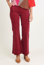 Model Madeline wearing size 10 of the Dharma Pant in colour Cranberry (Red), from the front, cropped image