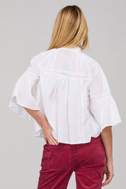 A model wearing the Haru Embroidered Shirt in colour White (White), from the back