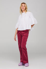 A model wearing the Haru Embroidered Shirt in colour White (White), from the front, showing the whole outfit