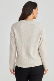 A model wearing the Saintly Knit in colour Parchment, from the back