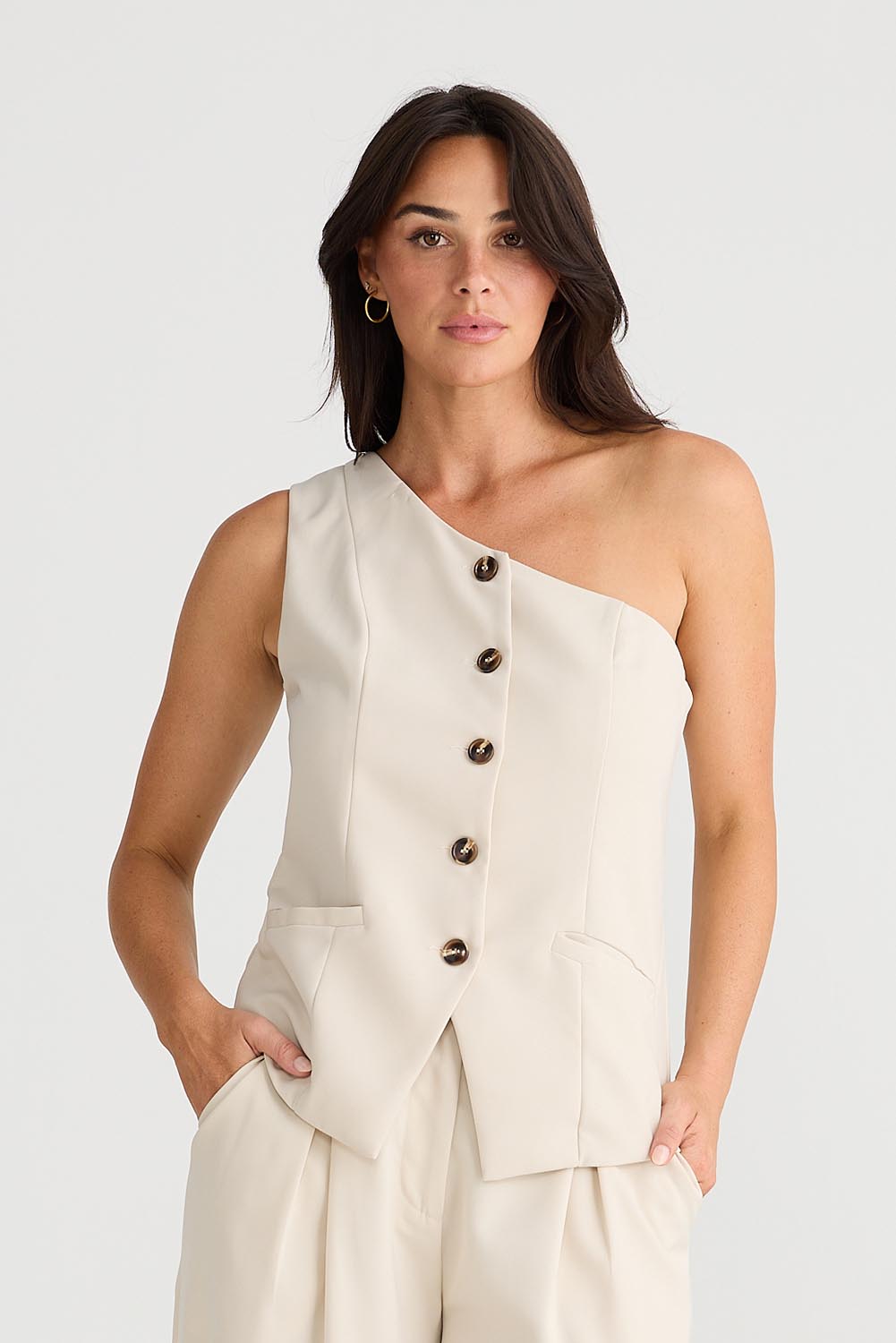 A model wearing the Rozalia Asymmetric Top in colour Oyster, from the front, cropped image
