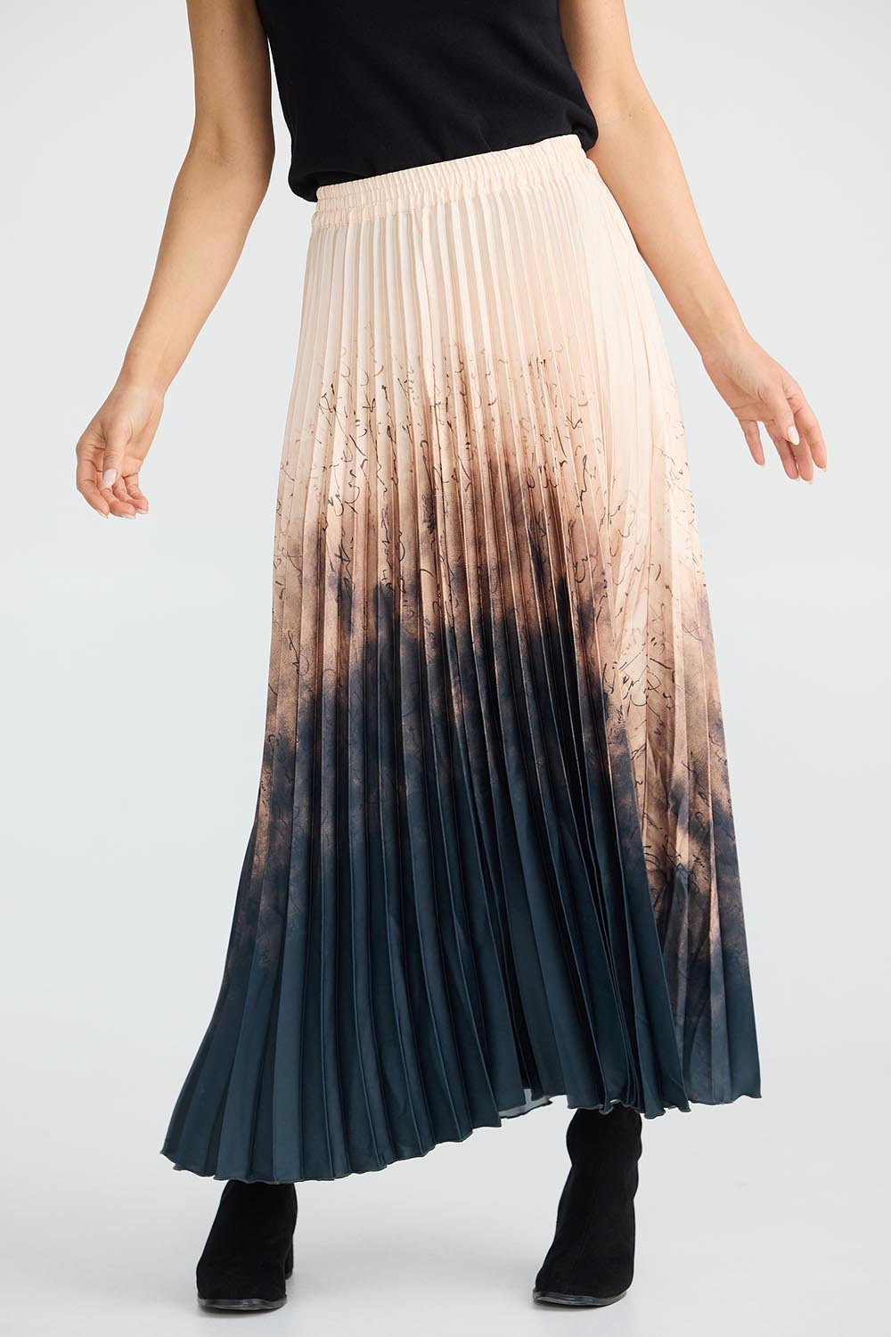 A model wearing the Alias Pleated Skirt in colour Calligraph, from the front, cropped image