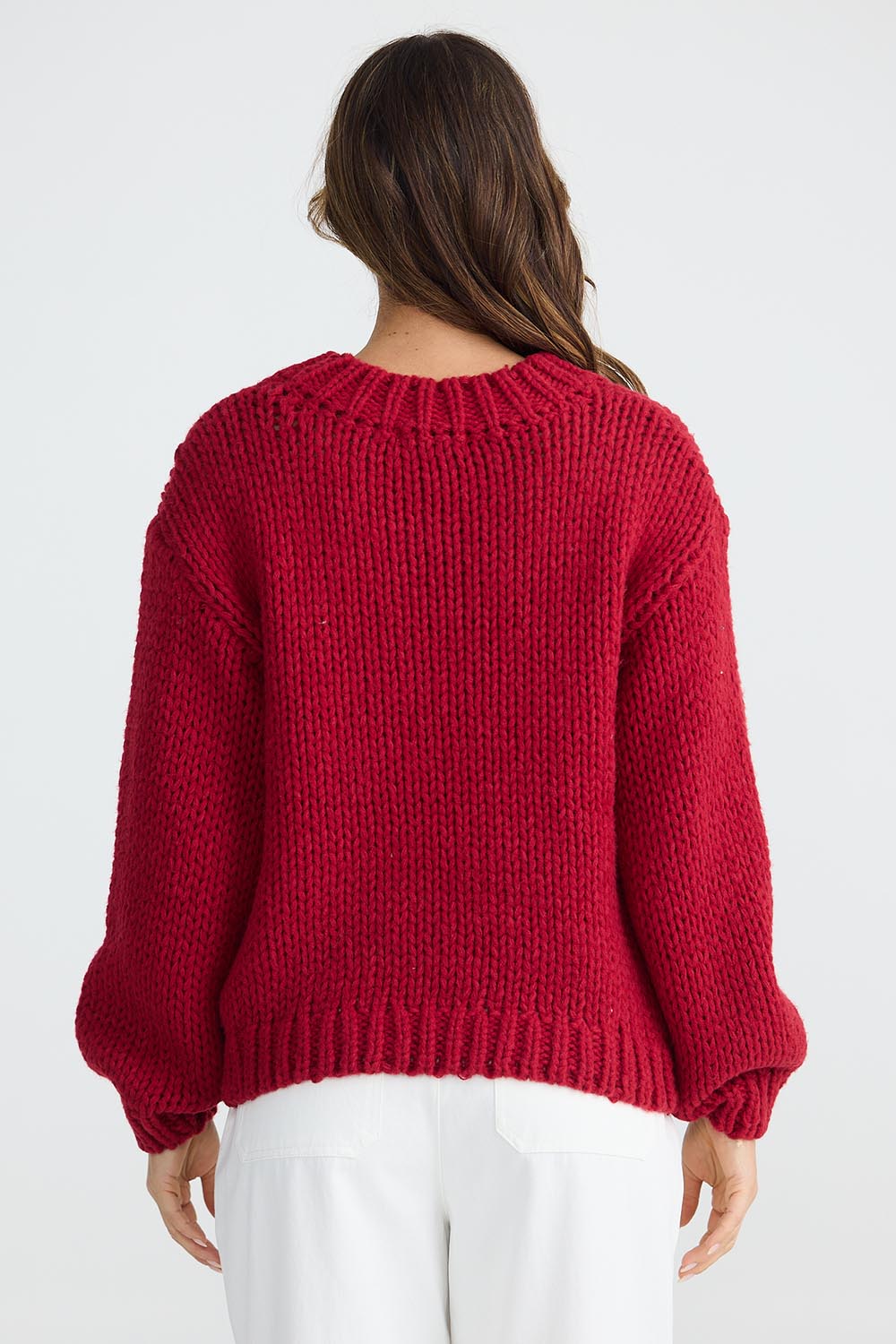 A model wearing the Heart On My Sleeve Knit in colour Cherrywhit (Red), from the back
