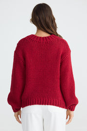 A model wearing the Heart On My Sleeve Knit in colour Cherrywhit (Red), from the back