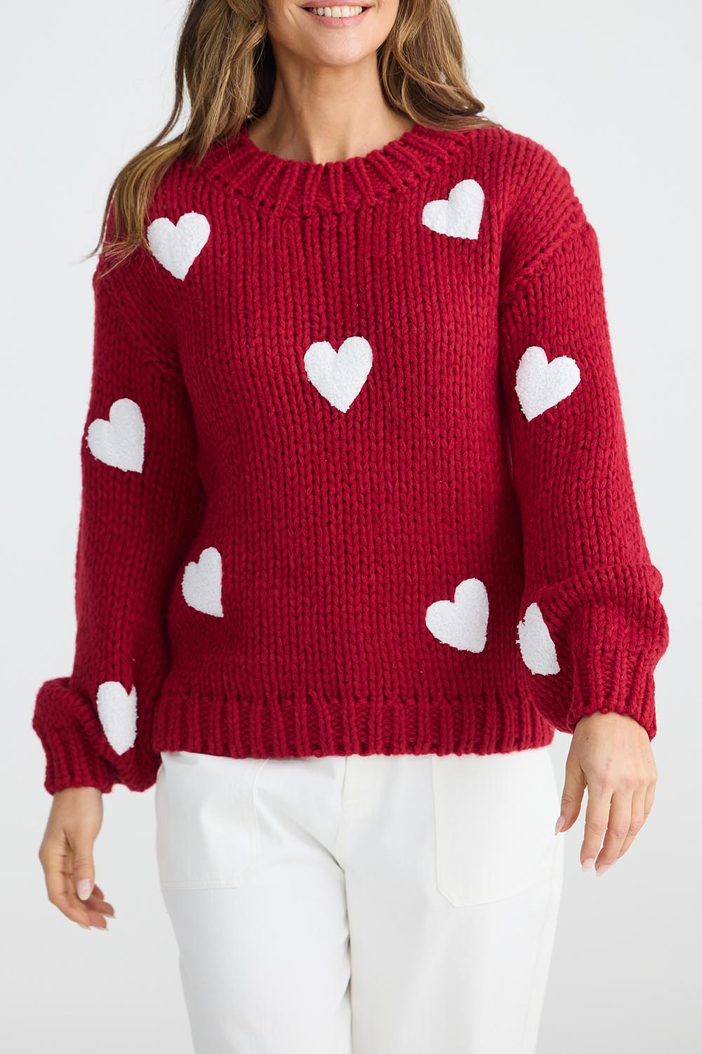 A model wearing the Heart On My Sleeve Knit in colour Cherrywhit (Red), from the front, cropped image