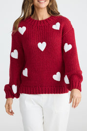 A model wearing the Heart On My Sleeve Knit in colour Cherrywhit (Red), from the front, cropped image