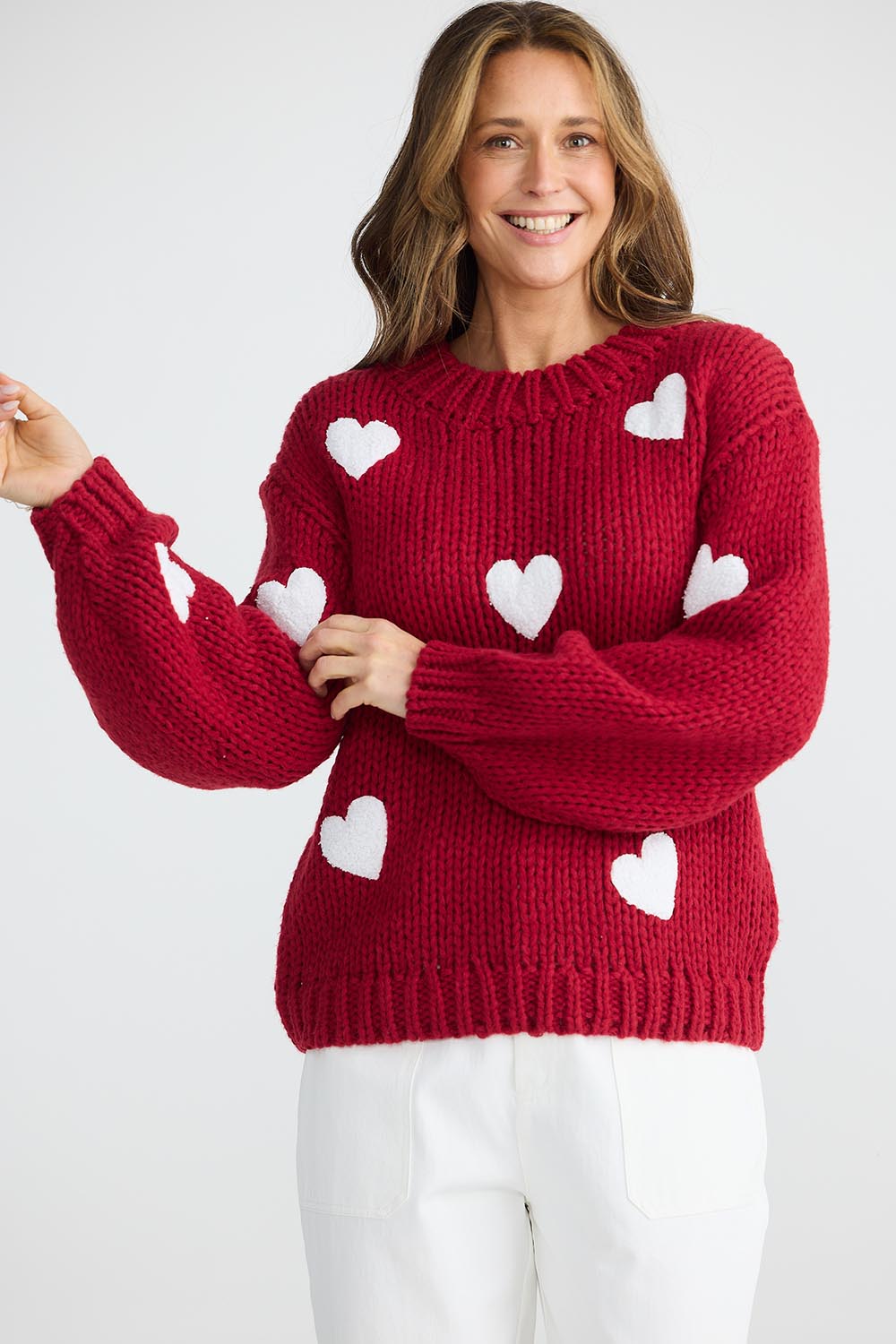 A model wearing the Heart On My Sleeve Knit in colour Cherrywhit (Red), from the front, cropped image