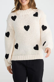 A model wearing the Heart On My Sleeve Knit in colour Offwhite (White), from the front, cropped image