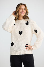 A model wearing the Heart On My Sleeve Knit in colour Offwhite (White), from the front, cropped image