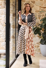 A model wearing the Lucy Dress in colour Vienna, from the front, showing the whole outfit