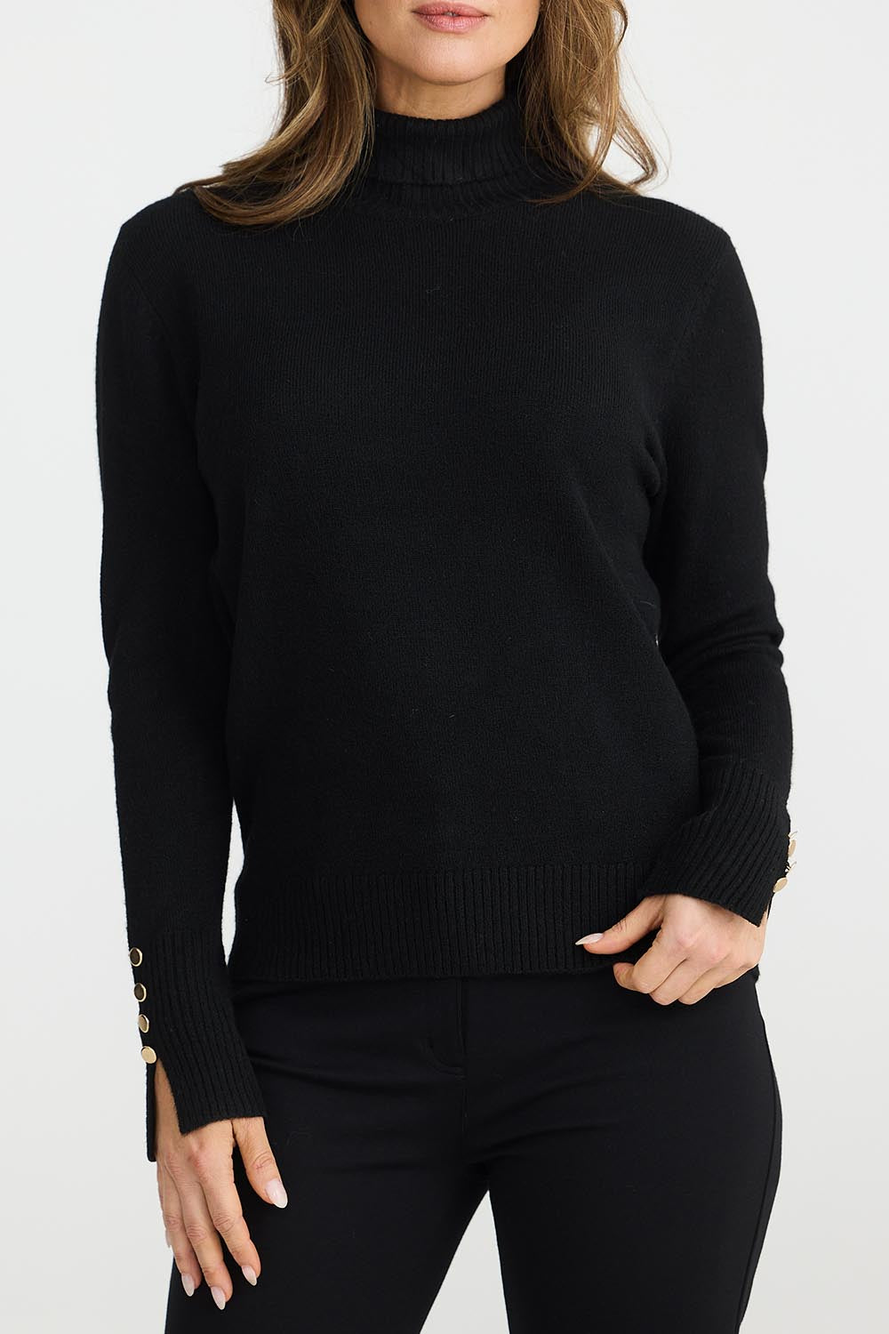 A model wearing the Pilot Knit in colour Black (Black), from the front, cropped image