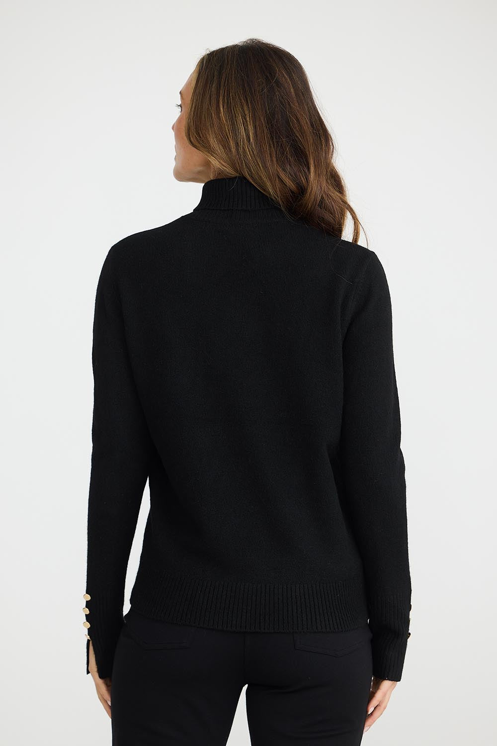 A model wearing the Pilot Knit in colour Black (Black), from the front, showing the whole outfit