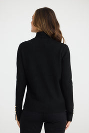 A model wearing the Pilot Knit in colour Black (Black), from the front, showing the whole outfit