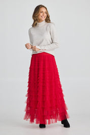 A model wearing the Chance Skirt in colour Berryred (Red), from the front, showing the whole outfit