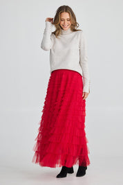 A model wearing the Chance Skirt in colour Berryred (Red), from the front, showing the whole outfit
