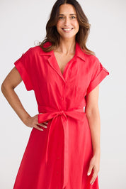 A model wearing the Versailles Cotton Dress in colour Chilli (Red), from the front, cropped image