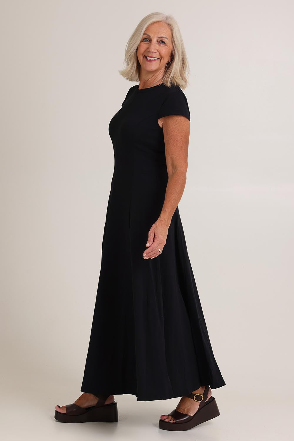 Model Sandy wearing size S of the Sylvie Cotton Dress in colour Black (Black), from the front, showing the whole outfit