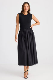 A model wearing the Daphne Cotton Dress in colour Black (Black), from the front, showing the whole outfit