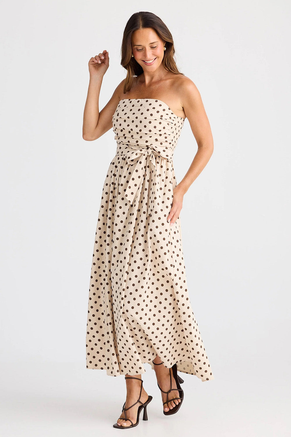 A model wearing the Avalon Cotton Maxi Dress in colour Chocpolka, from the front, showing the whole outfit