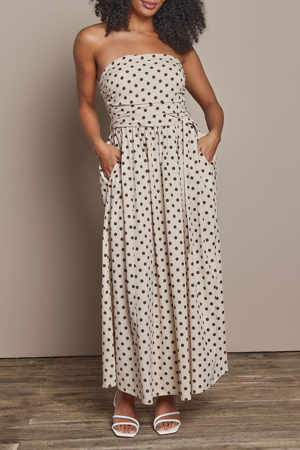 Model Ziara wearing size S of the Avalon Cotton Maxi Dress in colour Chocpolka, from the front, cropped image