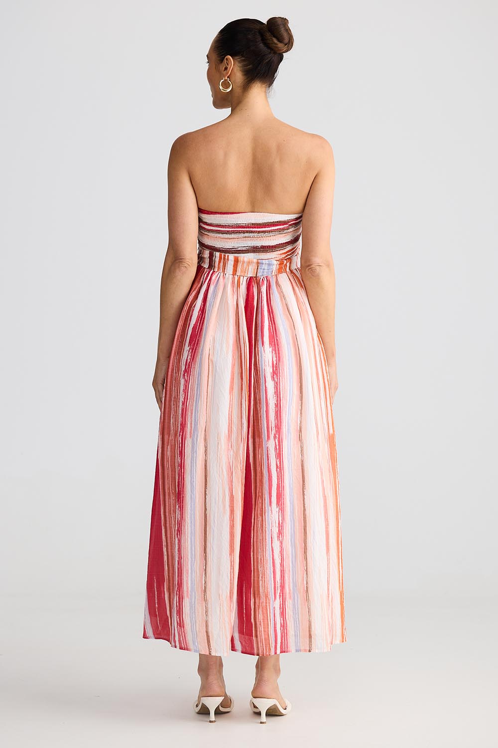 A model wearing the Avalon Dress in colour Painterly, from the back