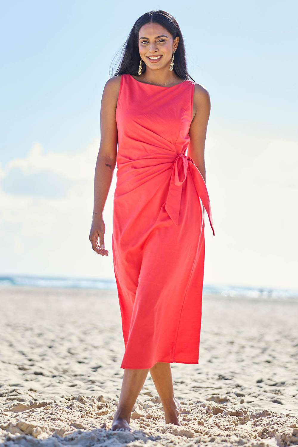 Model Eshan wearing size 10 of the Candice Dress - Coral in colour Coral, from the front