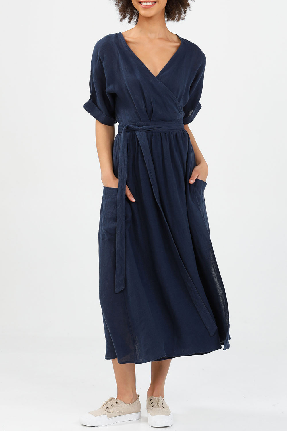 A model wearing the Pansies Wrap Dress in colour Navy (Blue), from the front, cropped image
