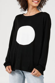 A model wearing the Petra Spot Knit in colour Blkwhite (Black), from the front, cropped image