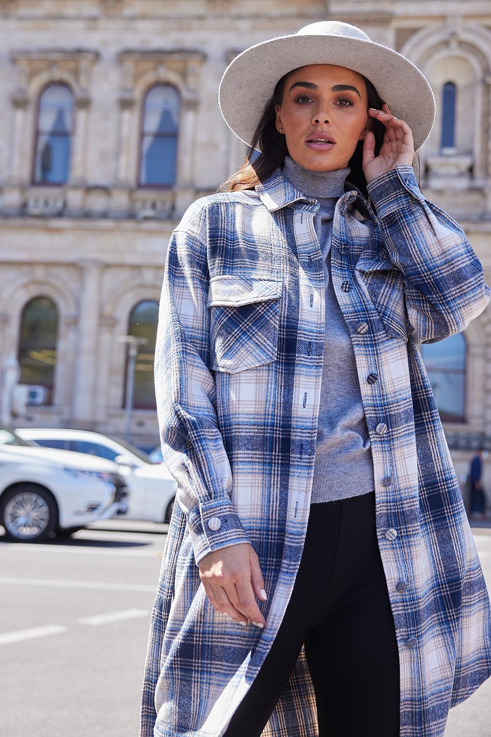 A model wearing the Trinity Coat in colour Bluechar (Blue), from the front, showing the whole outfit