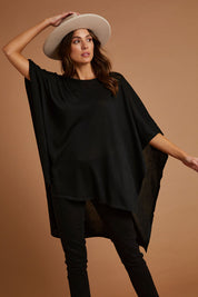 Model Madeline wearing size OneSize of the Vaasa Top in colour Black (Black), from the front, showing the whole outfit