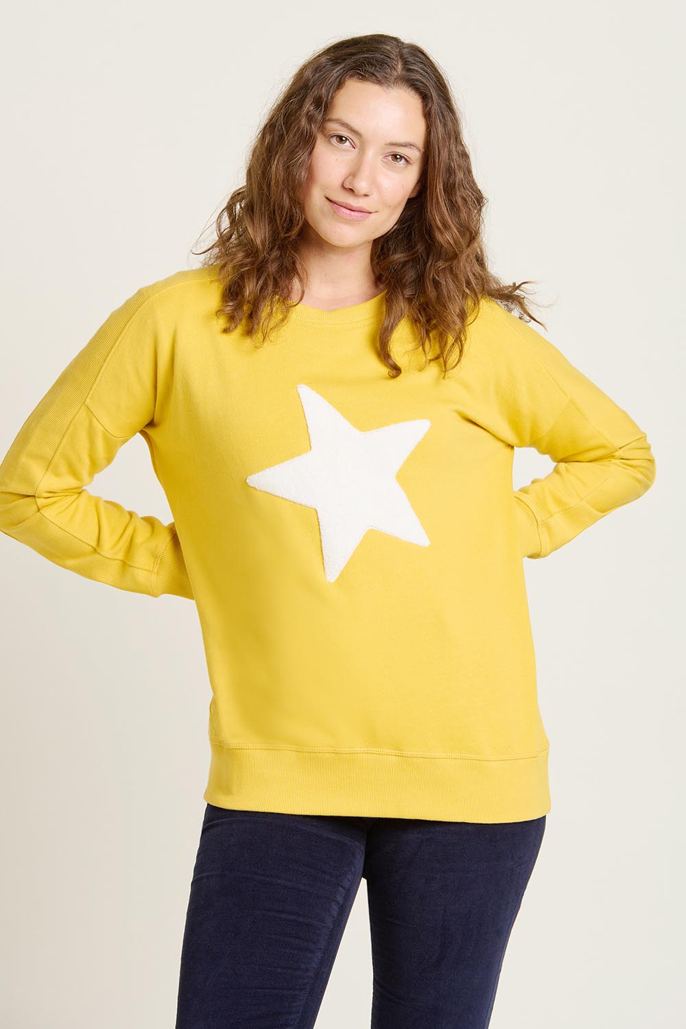 A model wearing the Star Crew Neck Cotton Sweatshirt in colour Mustard, from the front, cropped image