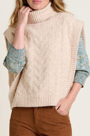 A model wearing the Cable Knitted Vest in colour Natural, from the front, cropped image