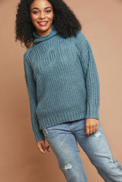 Model Ziara wearing size 10 of the Cable Knitted Roll Neck Jumper in colour Blue (Blue), from the front, showing the whole outfit