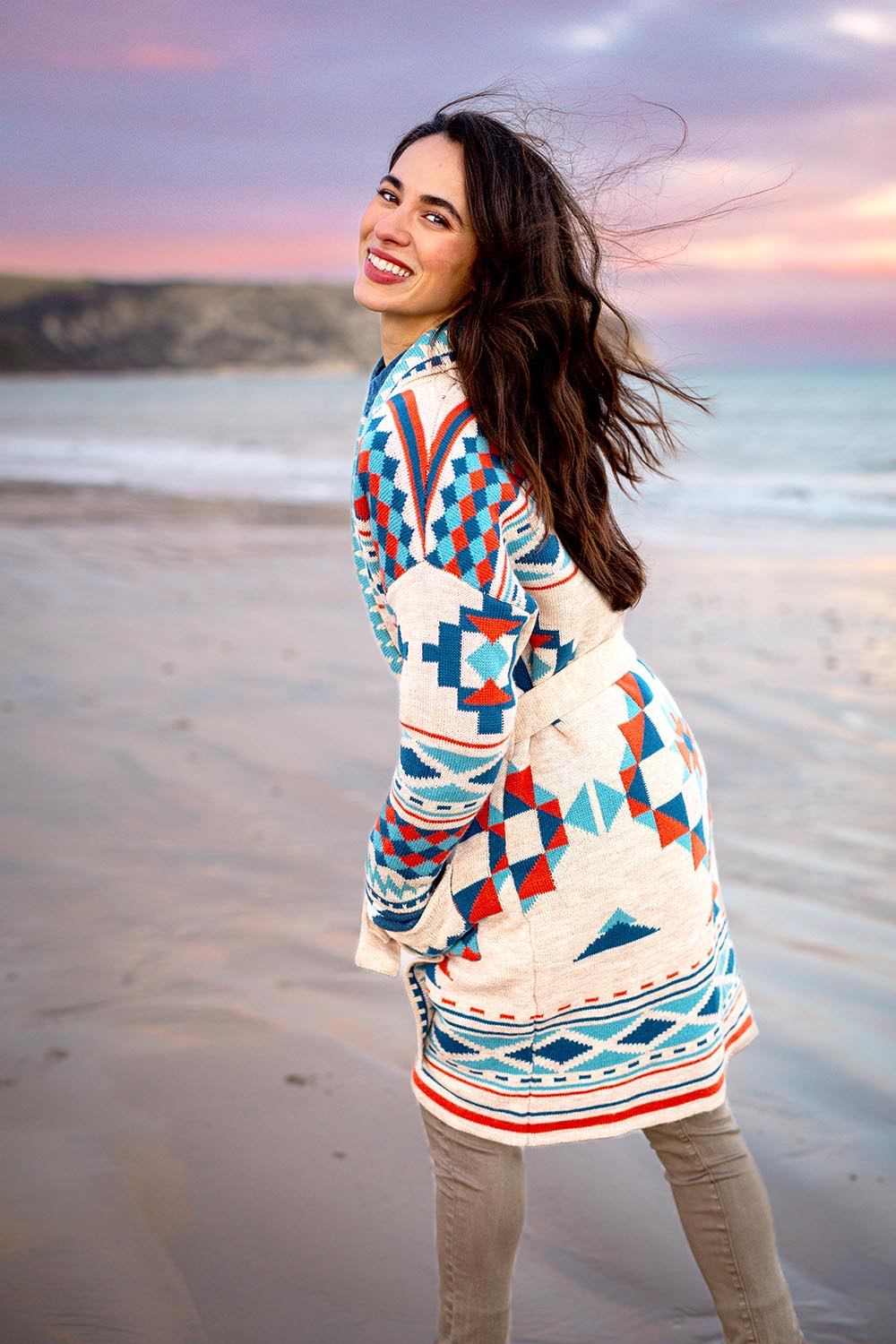 A model wearing the Geo Belted Wool Blend Knitted Cardigan in colour Multi, from the front, showing the whole outfit
