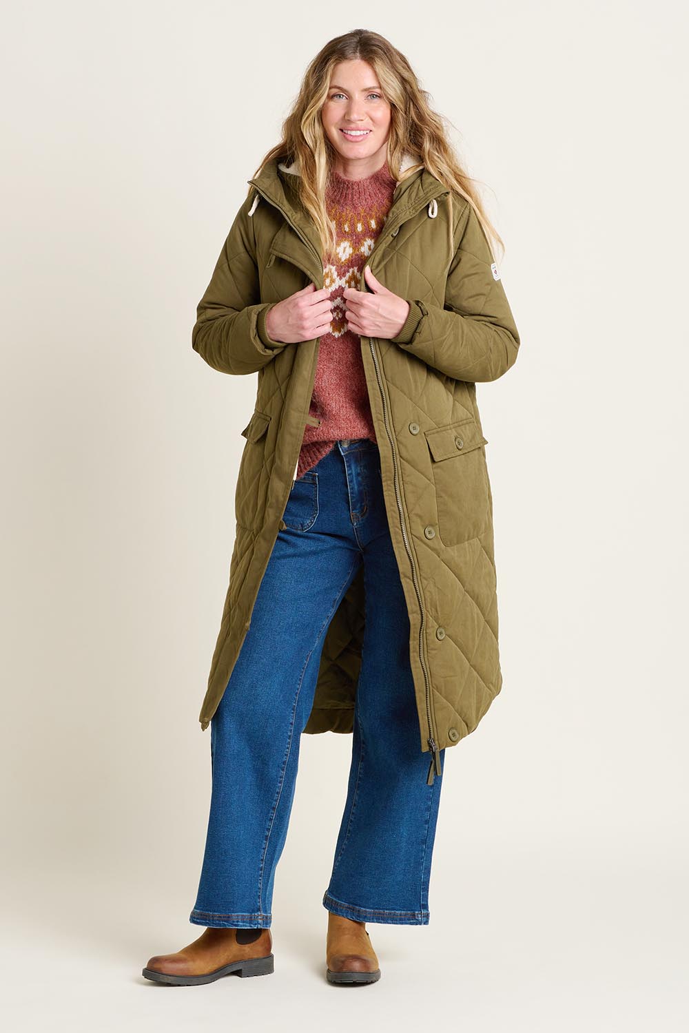A model wearing the Bradstock Hooded Parka Jacket in colour Khaki (Green), from the front, showing the whole outfit