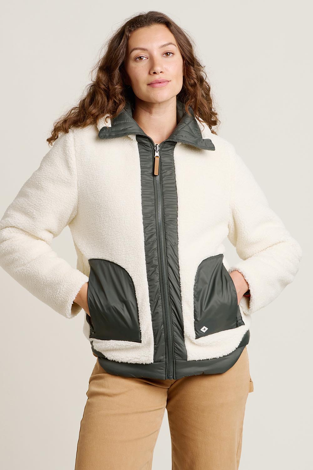 A model wearing the Fortunes Reversible Jacket in colour Multi (Green), from the front, cropped image